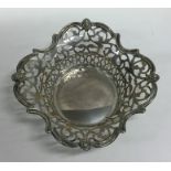 An Edwardian silver bonbon dish decorated with scr