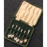 A set of five silver coffee spoons together with o