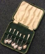 A set of five silver coffee spoons together with o