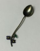 A silver and plique-à-jour spoon decorated with fl