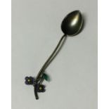 A silver and plique-à-jour spoon decorated with fl