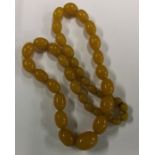 A good string of tapering amber type beads. Approx