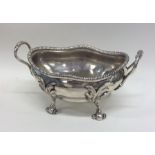 A George III silver butter dish on scroll feet wit