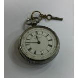 A silver open faced pocket watch with white enamel