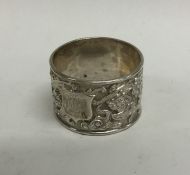 A Chinese silver napkin ring embossed with flowers