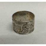 A Chinese silver napkin ring embossed with flowers