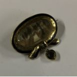 A good quality Georgian oval enamelled mourning brooch in t