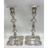 A good pair of George II cast silver candlesticks