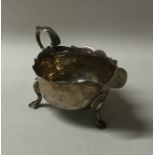 A George II silver sauce boat with card cut rim. L