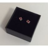 A pair of pink tourmaline ear studs in claw mounts