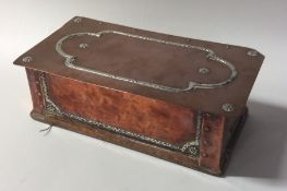 A stylish copper and silver mounted cigarette box.