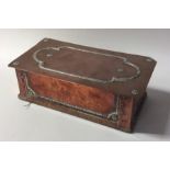 A stylish copper and silver mounted cigarette box.