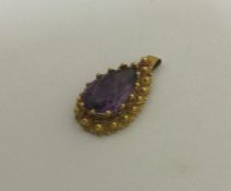 A Victorian high carat gold amethyst pendant. Appr