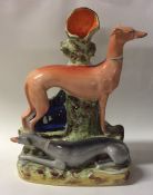A tall Staffordshire figure of two greyhounds with