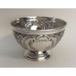 A good quality embossed silver sugar bowl on sweep