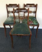 A set of three brass inlaid sabre leg chairs with