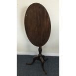 A small Georgian mahogany oval tilt top table. Est