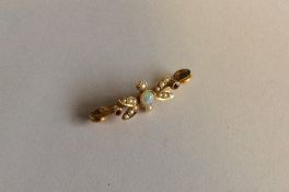 An opal and ruby bar brooch in 15 carat. Approx. 2