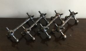 A set of four silver plated knife rests with ball