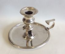 A circular Georgian silver chamber stick with reed