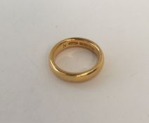 A 22 carat gold plain wedding band. Approx. 8.3 gr