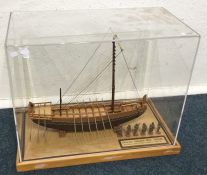 A cased handmade model of a pharaoh's ship with pe