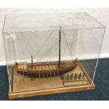 A cased handmade model of a pharaoh's ship with pe