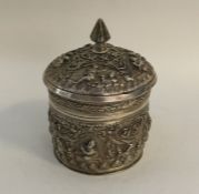 A heavy Indian silver cylindrical box decorated wi