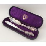 A pair of stylish silver plated butter knives cont