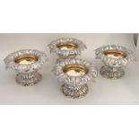 A fine set of four William IV silver salts with gi