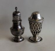 An Edwardian silver pepper together with one other