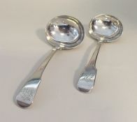 A pair of silver fiddle pattern sauce ladles. Punc