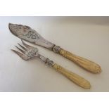 A pair of Victorian silver and carved ivory fish s