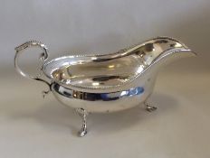 A heavy Edwardian silver sauce boat with bead edge