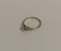 A diamond single stone ring in plain claw mount. A