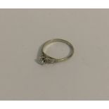 A diamond single stone ring in plain claw mount. A