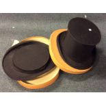 A pair of unusual collapsible bowler hats in a cas