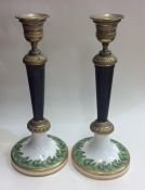 A pair of brass mounted and porcelain candlesticks