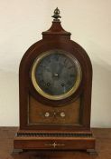 An Edwardian inlaid mahogany dome top mantle clock