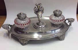 An attractive Victorian oval silver plated inkstan