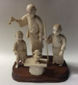 A large carved ivory group of three figures with r