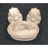 A group of three pottery jelly moulds together wit