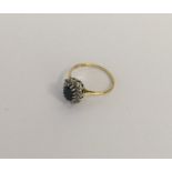 An 18 carat gold diamond and sapphire cluster ring