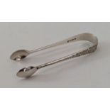 A pair of Victorian silver sugar tongs with bright