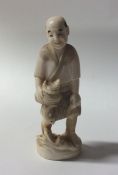 A carved ivory figure of a fisherman. Approx. 13 c