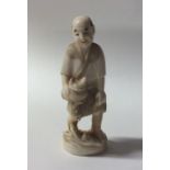 A carved ivory figure of a fisherman. Approx. 13 c