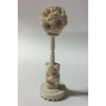 A carved ivory puzzle ball on stand. Approx. 16 cm