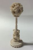 A carved ivory puzzle ball on stand. Approx. 16 cm