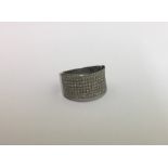 A large diamond band ring in white gold mount. App