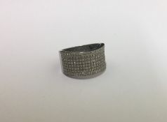 A large diamond band ring in white gold mount. App